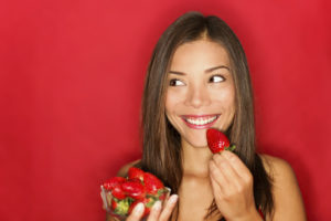 Girl eating strawberries